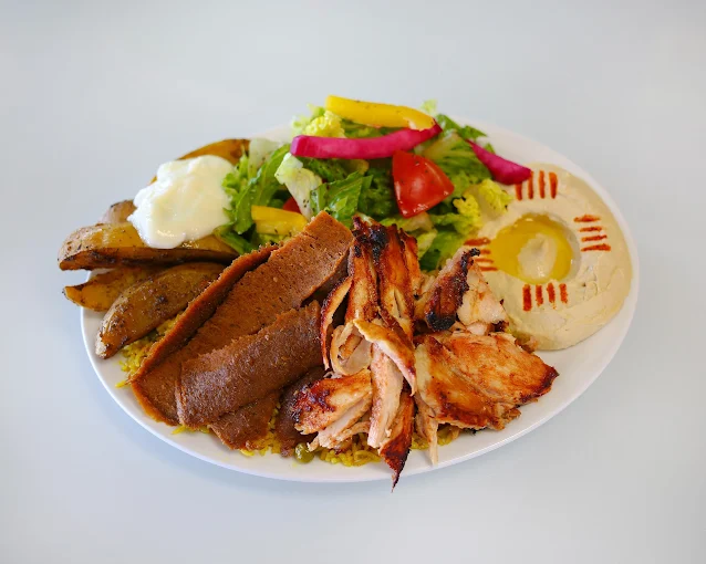 Fresh chicken shawarma platter with rice and garlic sauce at Empire Shawarma Calgary NW