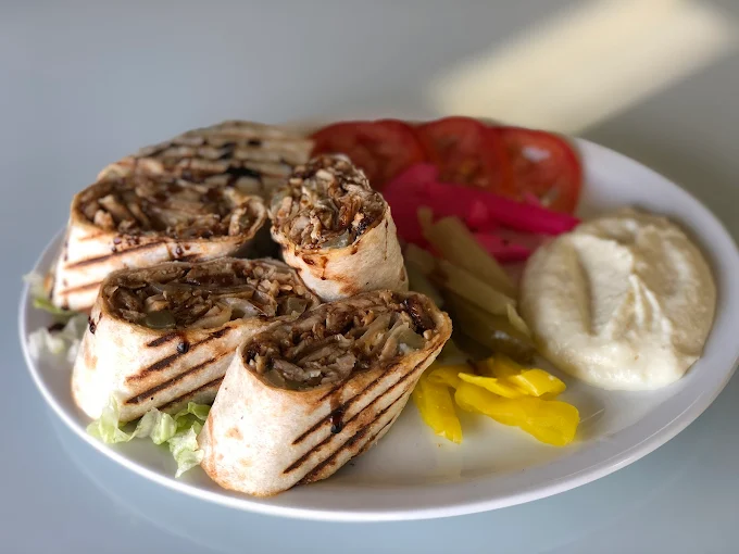 Chicken shawarma sandwich wrap with fresh toppings at Empire Shawarma Calgary NW